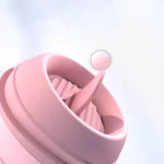 Close-up of the retractable silicone tongue extending from the base of the cat-shaped massager for targeted clitoral or nipple play.