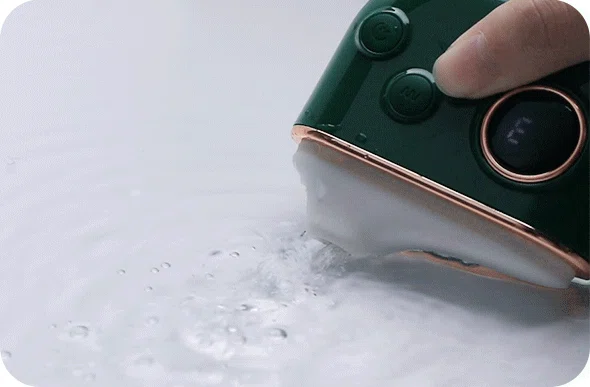 Close-up of the HH Luna Vault clitoral stimulator being rinsed under water, highlighting its IPX7 waterproof rating for easy cleaning and bath-time use.