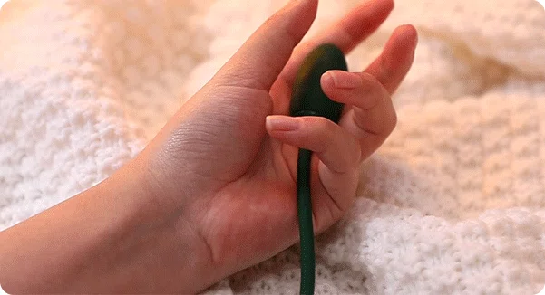 Handheld view of the ergonomic external vibrator attachment designed for targeted intimate stimulation.