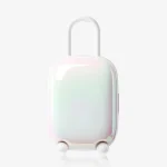 Minimalist product shot of the pearlescent white Magic Suitcase charging pod with a sleek, luggage-inspired aesthetic.