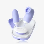 Main product shot of the lavender purple dual-motor pleasure set resting in its white ergonomic charging and storage base.