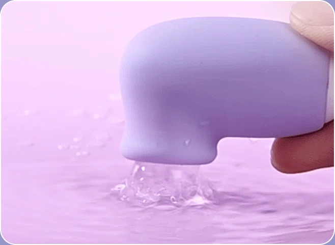Water-resistant clitoral stimulator being cleaned under a stream of water, highlighting the high-quality body-safe silicone and easy-to-maintain design.