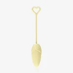 Minimalist studio shot of the yellow corn-textured pelvic floor trainer with a flexible silicone stem and decorative heart-shaped loop.