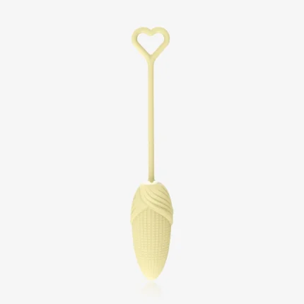 Minimalist studio shot of the yellow corn-textured pelvic floor trainer with a flexible silicone stem and decorative heart-shaped loop.