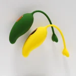 Close-up of two mango-shaped clitoral vibrators in lime green and sun-yellow colors, highlighting the flexible, body-safe silicone construction.