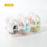 A 6-pack collection of colorful "Funny Egg" male pleasure devices in a clear, organized storage tray for discreet countertop placement.