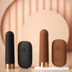 A collection of MILY intimacy tools in various colors including charcoal black and latte brown arranged on a modern geometric display.