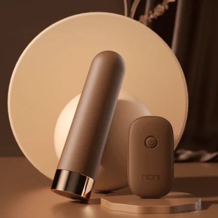 Elegant lifestyle shot of the MILY remote-controlled vibrator leaning against a circular decorative backdrop in a sophisticated earth-toned setting.