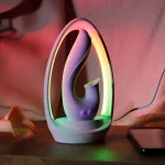 Elegant Moon Bud clitoral stimulator resting in its illuminated RGB charging base on a bedside table for a modern aesthetic.