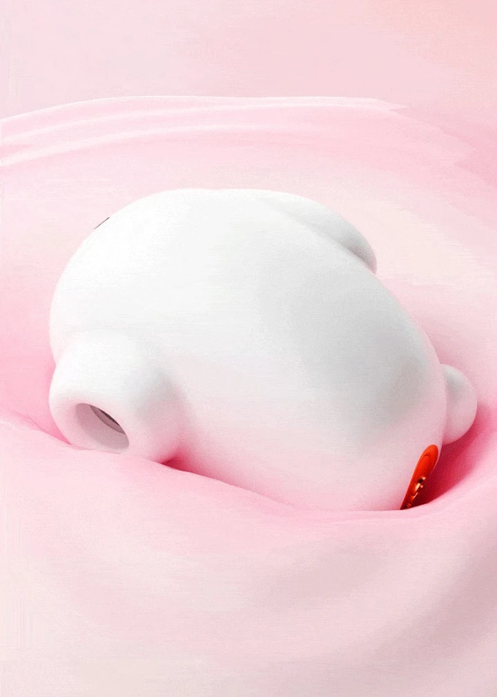 The Moon Rabbit air-pulsation vibrator partially submerged in a soft pink liquid, demonstrating its waterproof construction and easy-to-clean seamless body.