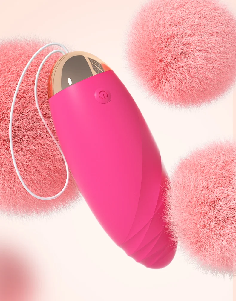 Close-up of a pink egg-shaped massager featuring a soft-touch finish and a secure retrieval cord for comfortable use.