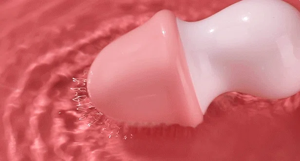 Fully waterproof intimacy toy being tested in water to demonstrate its submersible capability for bath or shower use.