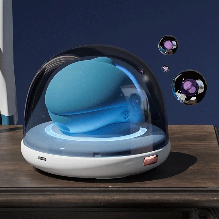 Aesthetic shot of the blue dolphin pleasure tool inside its protective sterilization dome, emphasizing the skin-like silicone texture.