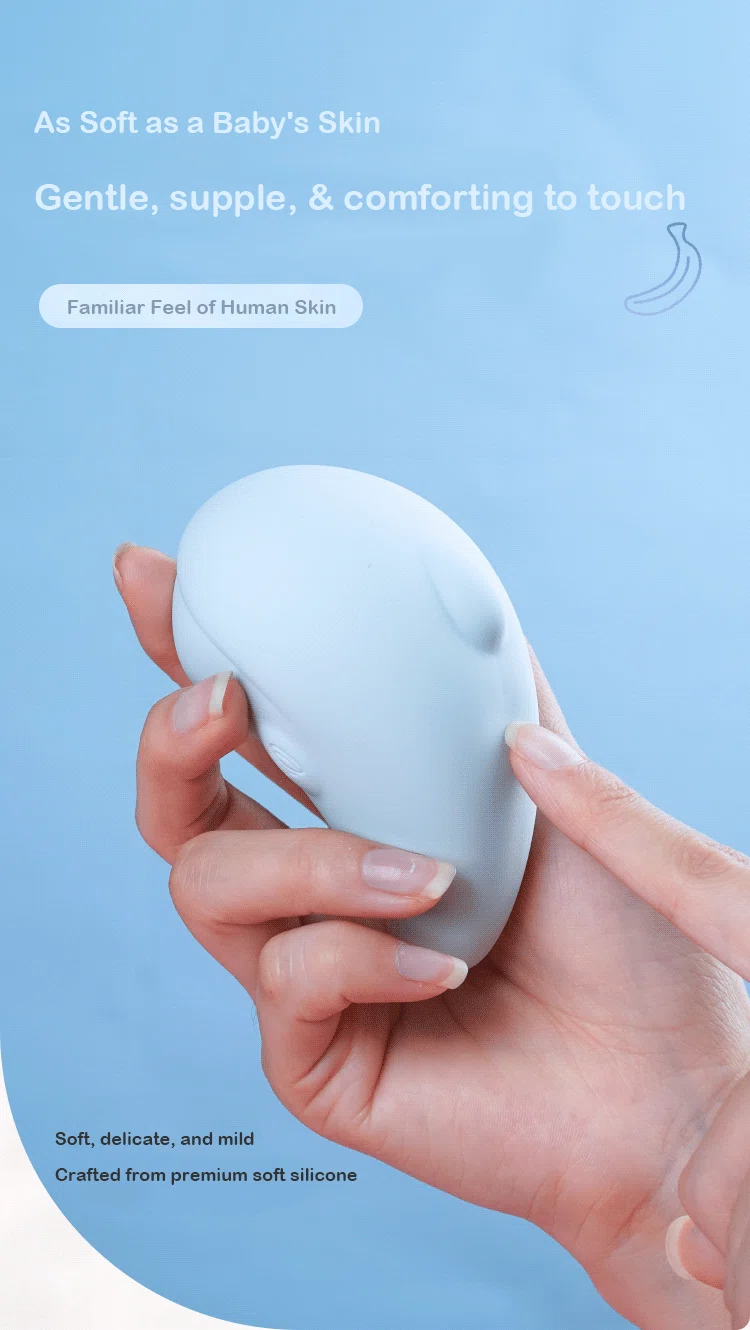 Close-up of a hand holding the ergonomic dolphin massager, highlighting the skin-like texture of the premium medical-grade soft silicone.