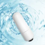 High-angle shot of the waterproof adult toy centered within a dynamic water splash, illustrating its durability and hygiene-focused design.