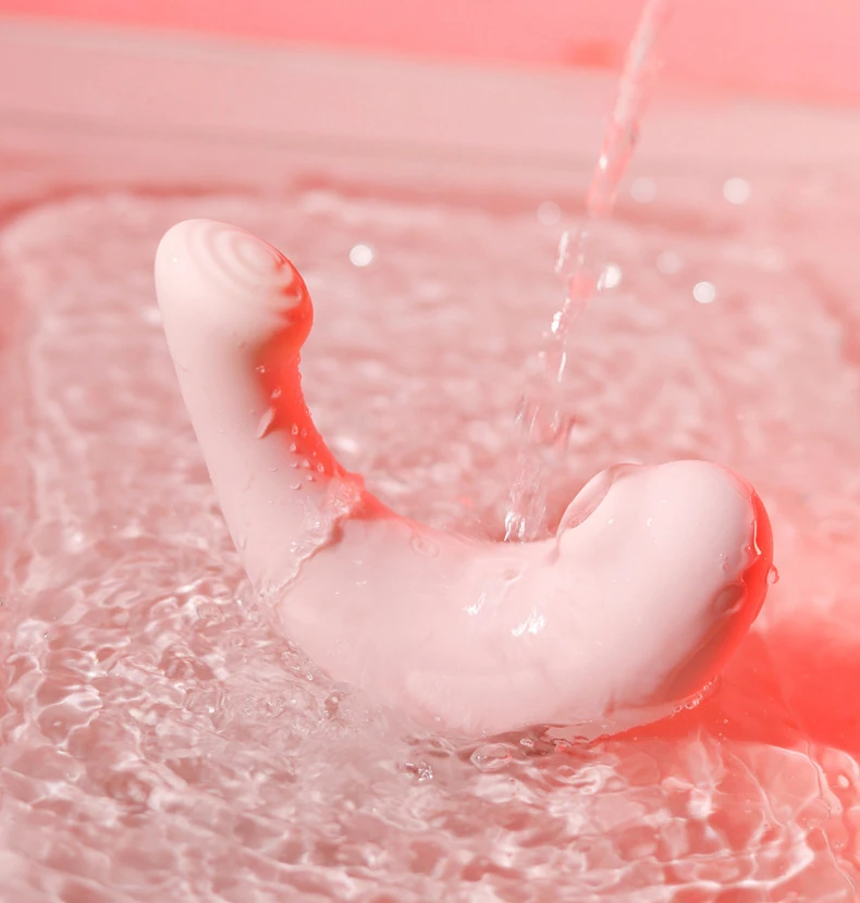 Waterproof HH Pebble intimacy tool being rinsed under running water, demonstrating its IPX7 rating and easy-to-clean medical-grade silicone surface.