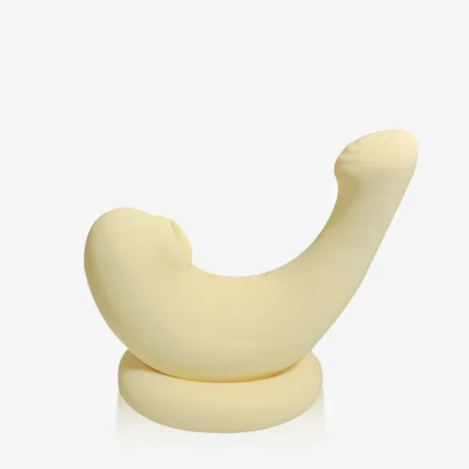 Studio shot of a waterproof silicone air-pulse stimulator resting on its wireless charging base for convenient and elegant storage.