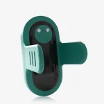 High-resolution view of the teal-colored silicone finger ring stimulator focusing on the magnetic charging interface and power button.