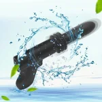 Waterproof black pistol-shaped vibrator splashing in blue water with green leaves, highlighting aquatic-safe pleasure.