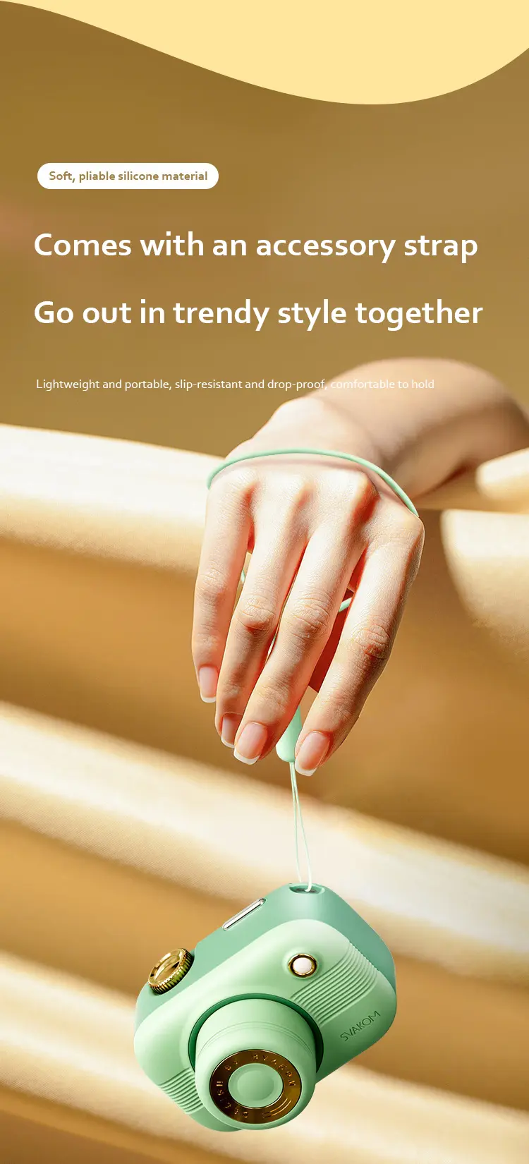 Soft, pliable silicone clitoral stimulator held by a wrist strap, emphasizing its lightweight, portable, and drop-proof design for trendy on-the-go use.