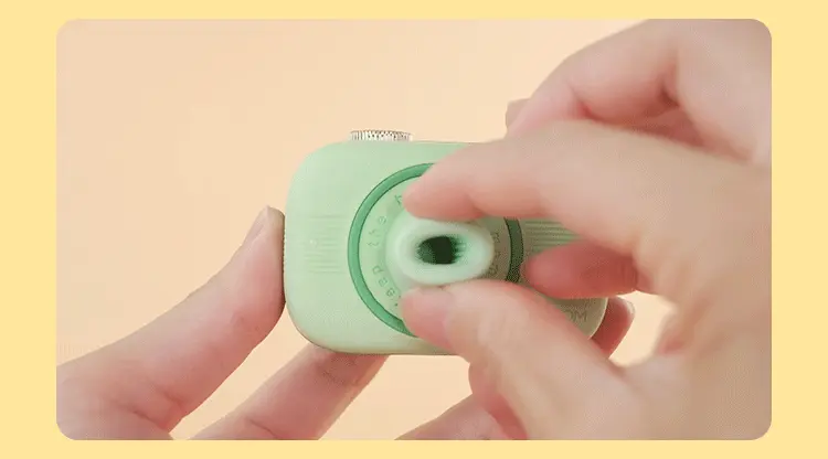 Close-up of a user’s hands demonstrating the flexible and skin-friendly silicone texture of the clitoral suction nozzle on a compact pleasure device.