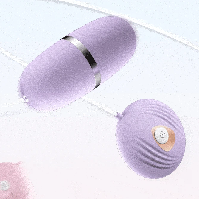 Detailed texture shot of the purple vibrating love egg, highlighting the ribbed ridges on the shell-shaped controller designed for tactile grip and ease of use.