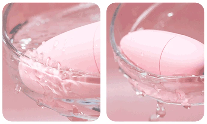 Waterproof adult toy demonstration showing the submersible silicone device splashing in water to illustrate its easy-to-clean design.