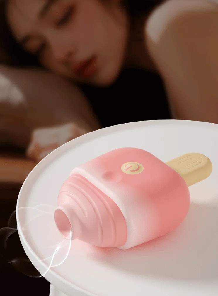 Lifestyle shot of a discreet Sweet Melt clitoral stimulator resting on a bedside table, emphasizing its cute, non-intimidating aesthetic for home use.