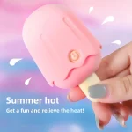 Discreet handheld vibrator with a playful ice cream aesthetic being held to demonstrate its compact, travel-friendly size.