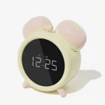 Digital bedside alarm clock featuring a discreet dual-attachment design in pastel yellow and peach for subtle home placement.