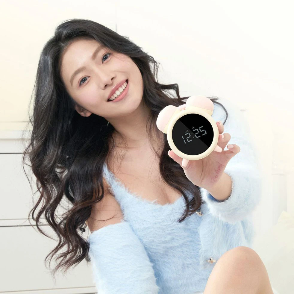 Portrait of a user holding the compact, aesthetically pleasing alarm clock vibrator, showcasing its palm-sized and non-intimidating design.