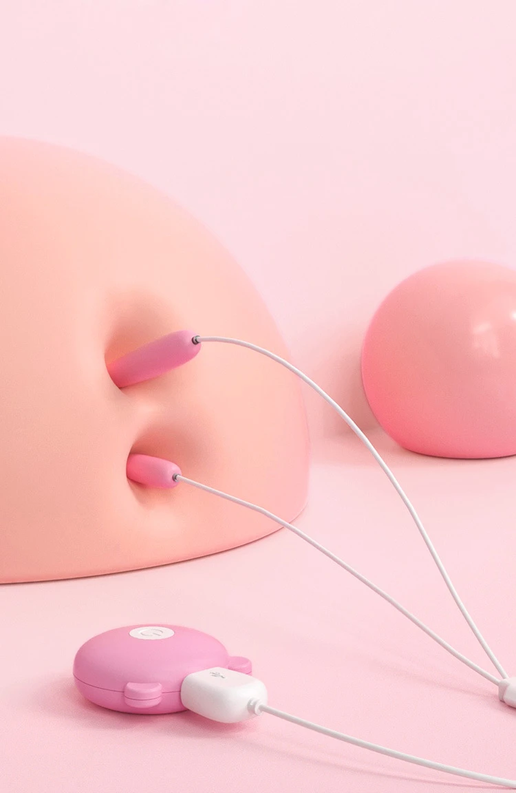 Lifestyle view of the USB-powered intimate vibrator with its dual stimulation tips resting on a smooth, pink background, highlighting its ergonomic and sleek aesthetic.