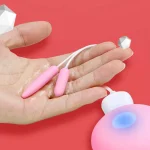 Demonstration of the vibrating fingertip tool being held in a hand to show its ultra-compact size and discreet design for portable use.