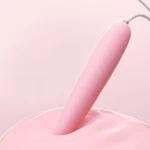 Close-up of the long-tapered silicone tip of the clitoral massager, emphasizing the smooth texture and high-quality material used for sensitive areas.