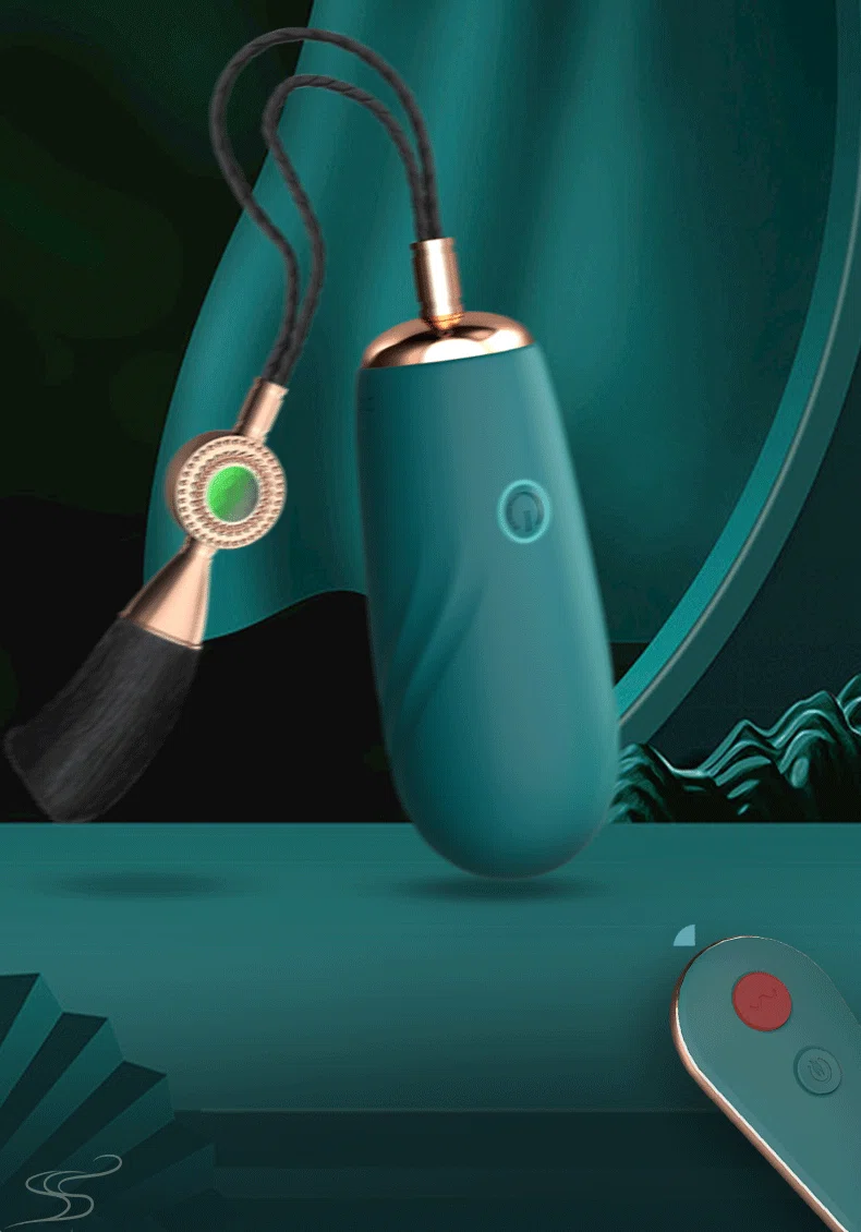 Emerald green Yu Beauty vibrator featuring a traditional Chinese-style silk tassel and matching remote control on a decorative pedestal.