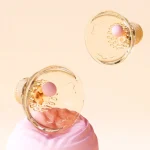 Transparent orange cat paw nipple massager set with domed cups and soft inner silicone spikes