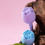 Pastel rose shaped adult pleasure devices in lavender and blue displayed in a romantic lifestyle setting