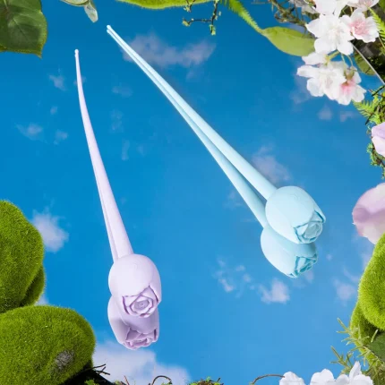 Lavender and blue rose bud vibrators reflected on mirror surface with floral spring themed backdrop