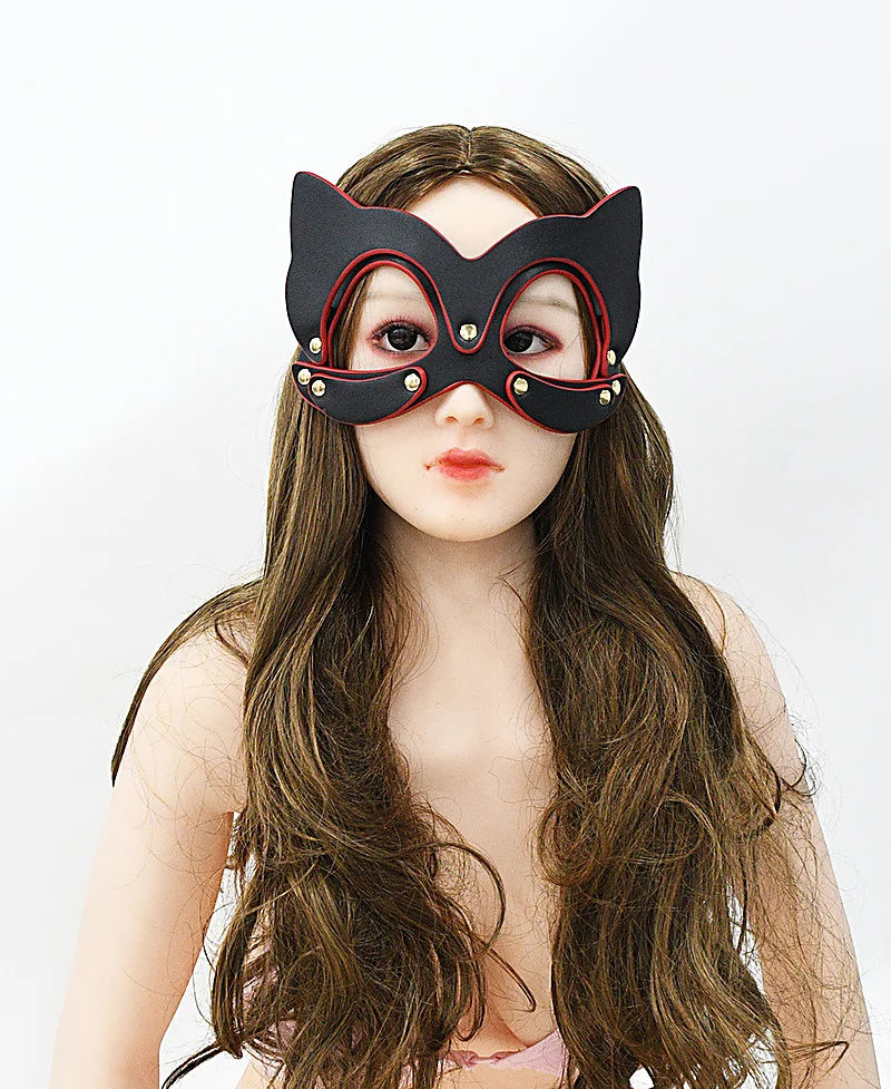 Front portrait of model wearing black and red cat eye mask with dramatic cosplay look