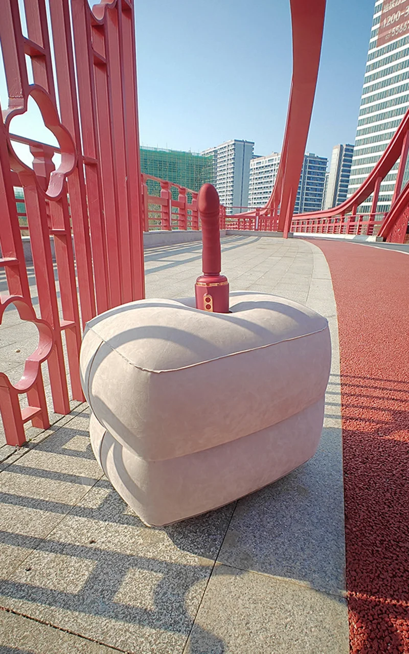 Inflatable sex position stool with attached vibrator on a red bridge walkway