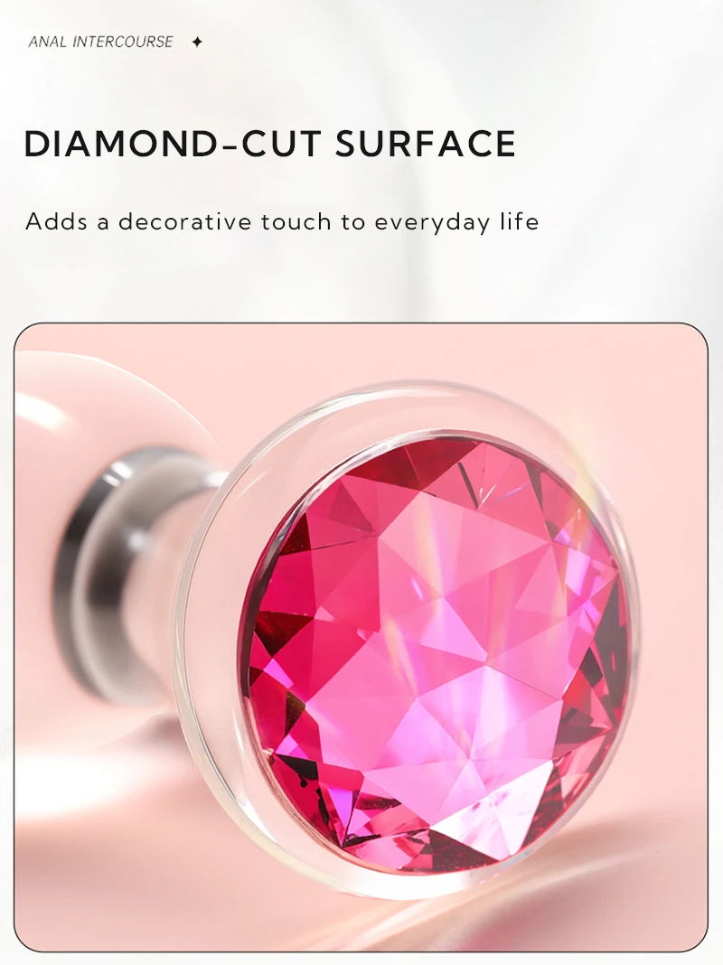 Close-up of clear glass anal plug with pink diamond-cut jewel base Discreet Sex Toys Brand - HooHss