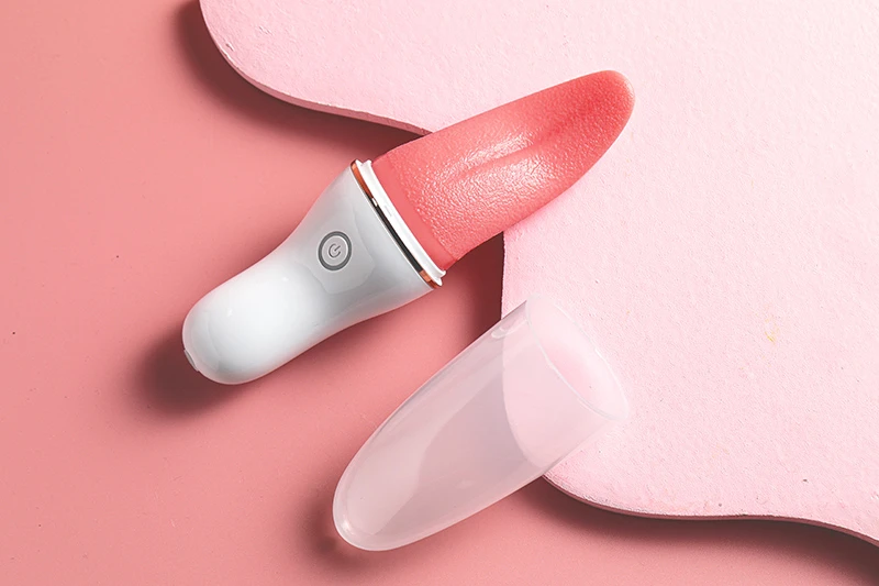 Tongue licking vibrator with protective cap on pink background Discreet Sex Toys Brand - HooHss