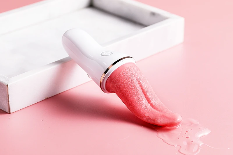 Tongue licking vibrator with textured pink tongue-shaped tip on pink surface Discreet Sex Toys Brand - HooHss