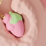 Strawberry keychain vibrating egg in soft pink with green leaf detail Discreet Sex Toys Brand - HooHss