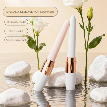 Slim beginner vibrator with rose gold accents displayed among stones and white flowers Discreet Sex Toys Brand - HooHss